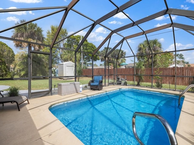 view of swimming pool featuring an outbuilding, fence, a storage shed, and a patio