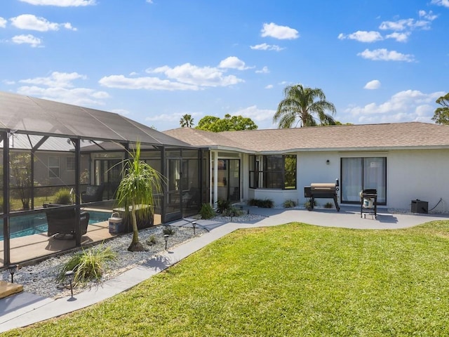 back of property with stucco siding, a lawn, a patio area, glass enclosure, and an outdoor pool