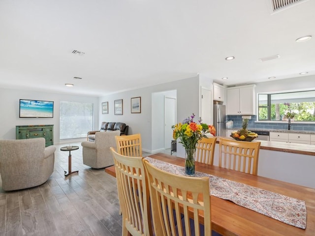 dining area with recessed lighting, visible vents, and light wood-style flooring