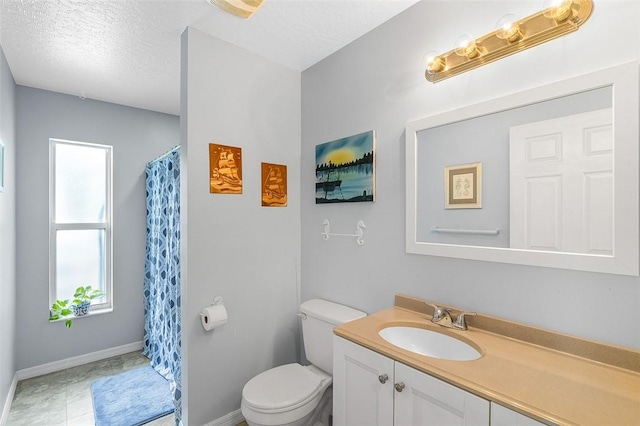 full bath with vanity, a shower with shower curtain, baseboards, a textured ceiling, and toilet