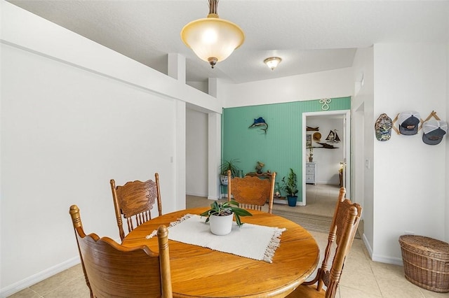 dining room featuring light tile patterned flooring and baseboards