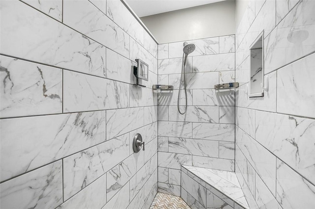 bathroom with a tile shower