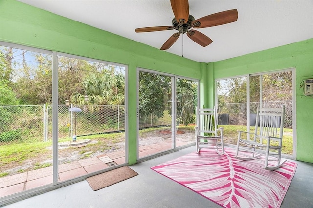 unfurnished sunroom featuring a ceiling fan