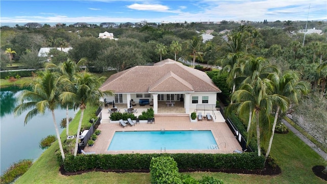 view of pool with outdoor lounge area, a patio area, a yard, and a water view