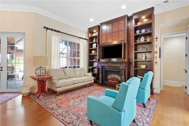 living room featuring light wood-type flooring and crown molding