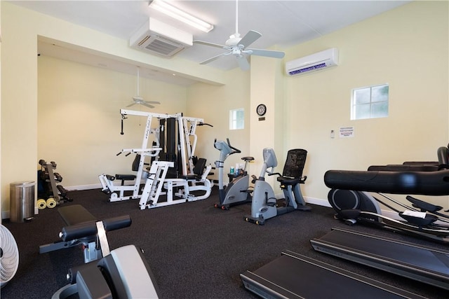 workout area with a wall mounted air conditioner and ceiling fan