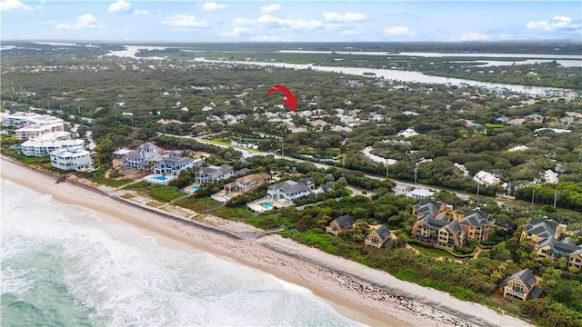 bird's eye view featuring a view of the beach and a water view