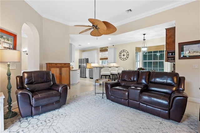 living room featuring ceiling fan, light tile patterned floors, and crown molding