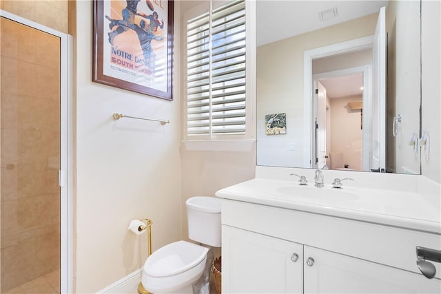 bathroom with vanity, toilet, and a shower with door