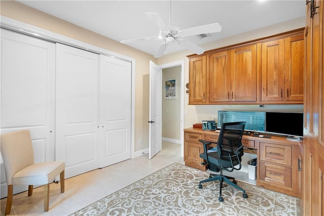 tiled office space with ceiling fan