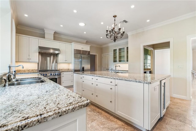 kitchen featuring a kitchen island with sink, sink, exhaust hood, decorative light fixtures, and high quality appliances