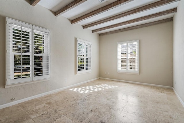 unfurnished room featuring beam ceiling