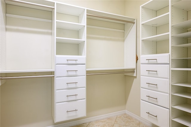 spacious closet with light tile patterned floors