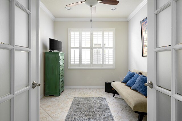 sitting room featuring ornamental molding, ceiling fan, and light tile patterned flooring