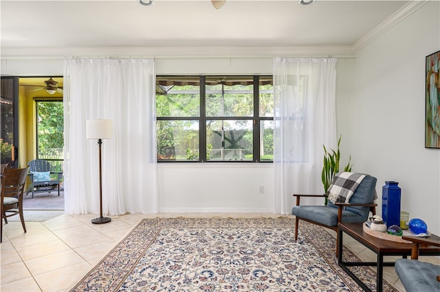 living area with light tile patterned floors, ceiling fan, and crown molding