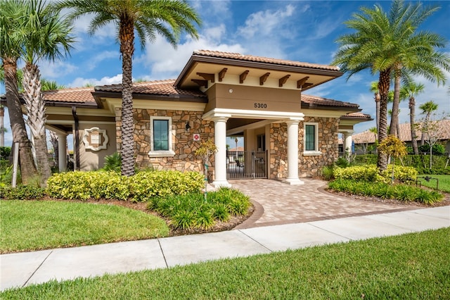 mediterranean / spanish house with a front yard