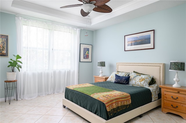 tiled bedroom with ceiling fan, a raised ceiling, and crown molding