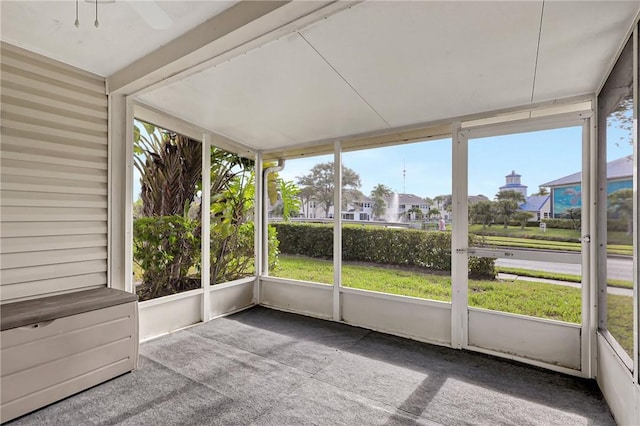 unfurnished sunroom with ceiling fan