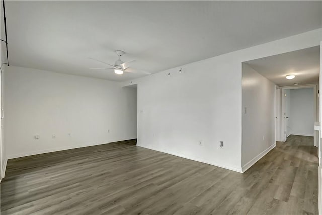 unfurnished room featuring ceiling fan, baseboards, and wood finished floors