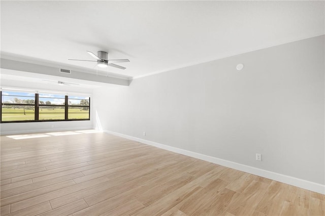 spare room with ornamental molding, ceiling fan, and light wood-type flooring