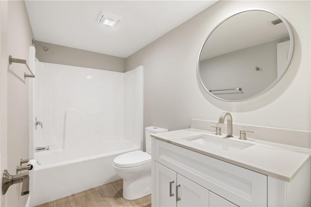 full bathroom featuring hardwood / wood-style flooring,  shower combination, vanity, and toilet