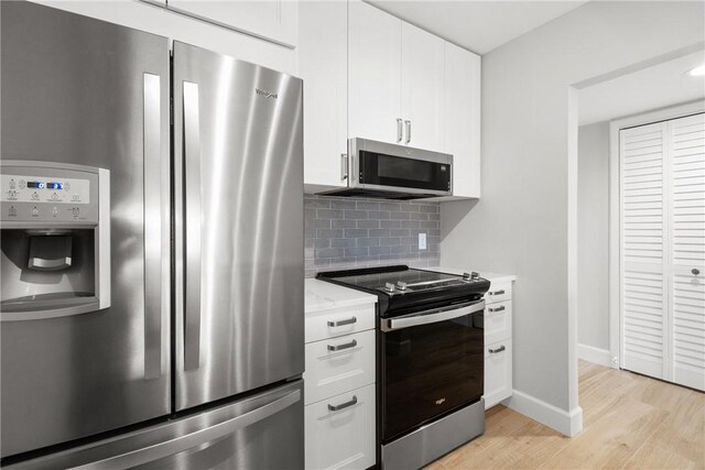 kitchen with ornamental molding, white cabinetry, sink, light hardwood / wood-style floors, and dishwasher