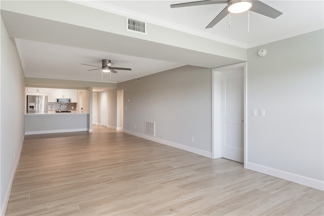 unfurnished living room with crown molding, ceiling fan, and light wood-type flooring