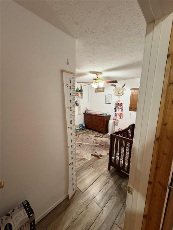 10595 88th St, Vero Beach, FL 32967 - hallway with a textured ceiling and wood finished floors