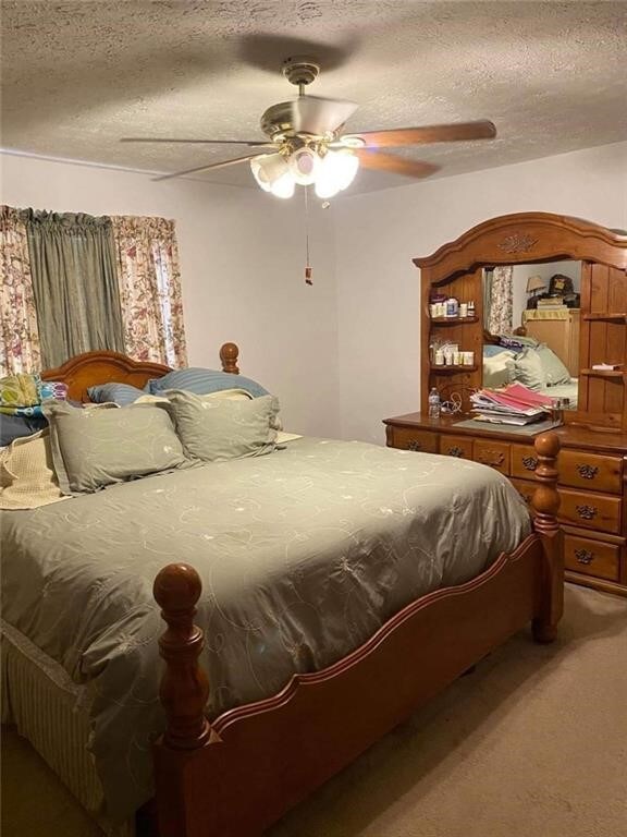 10595 88th St, Vero Beach, FL 32967 - carpeted bedroom with a textured ceiling and ceiling fan