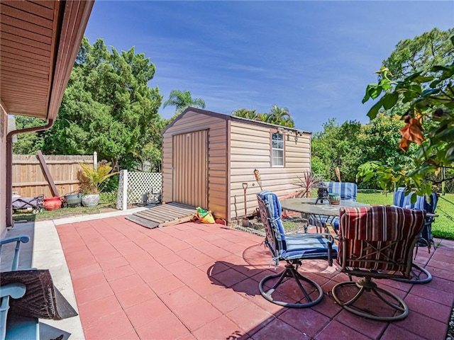 113 Larchmont Ter, Sebastian, FL 32958 - view of patio / terrace with a shed, fence, an outdoor structure, and outdoor dining space