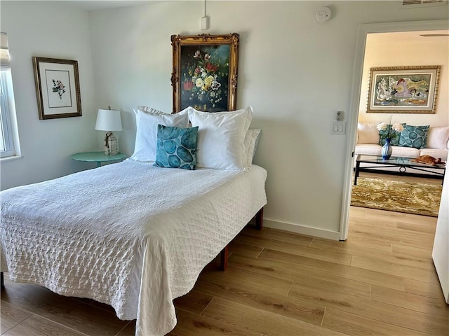 bedroom with light hardwood / wood-style floors