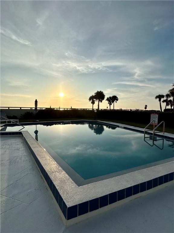 view of pool at dusk