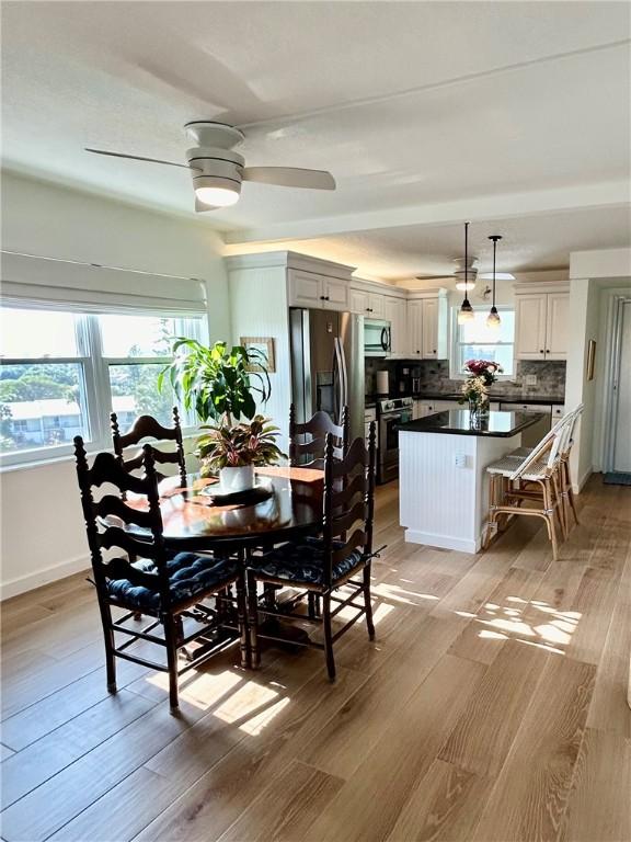 dining area featuring ceiling fan and light hardwood / wood-style floors