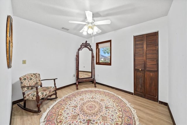 sitting room featuring light wood-type flooring and baseboards