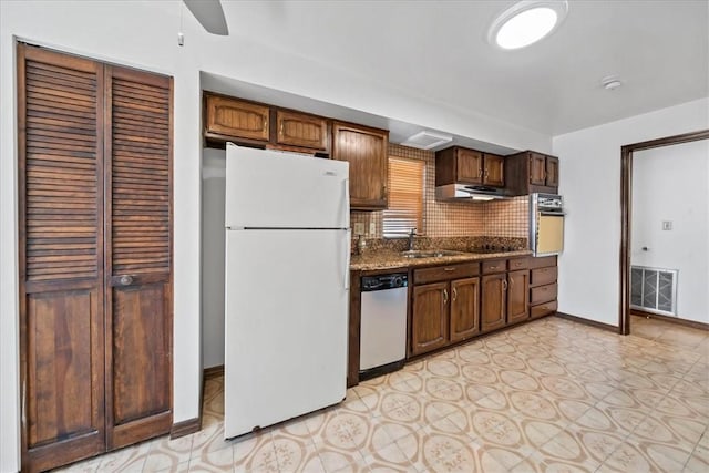 kitchen with freestanding refrigerator, stainless steel dishwasher, wall oven, range hood, and ceiling fan