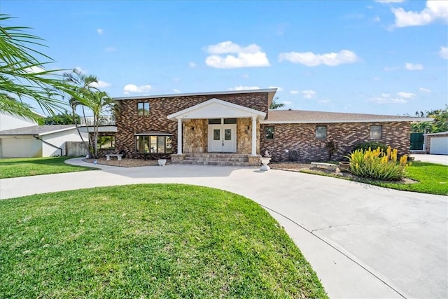 view of front of house with a front lawn and brick siding