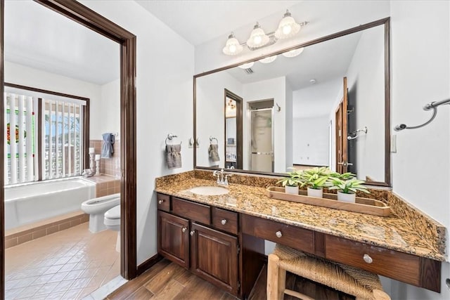 full bath featuring a bidet, vanity, a bath, toilet, and an enclosed shower