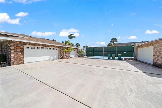 view of home's exterior featuring driveway and brick siding