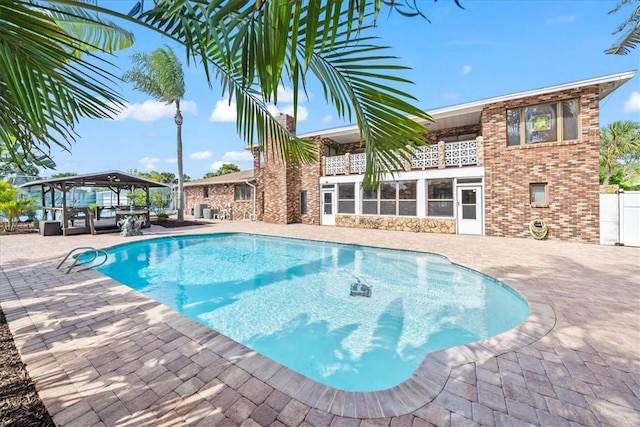outdoor pool featuring a patio, a gazebo, and outdoor lounge area
