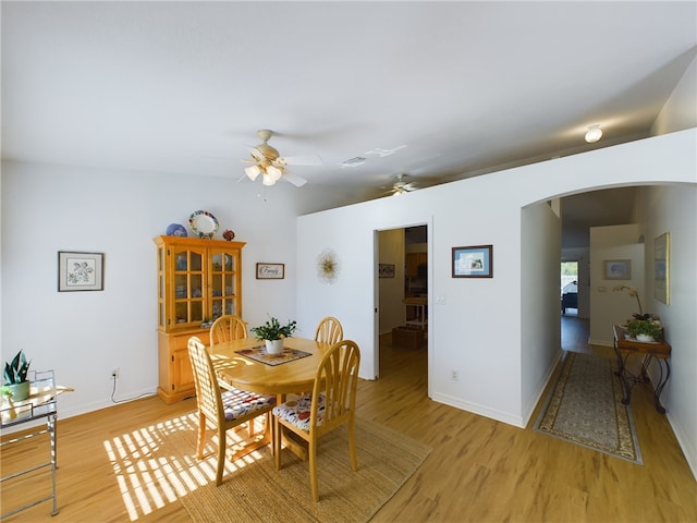 dining room with light hardwood / wood-style floors and ceiling fan