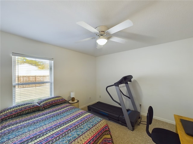 bedroom with ceiling fan and light carpet