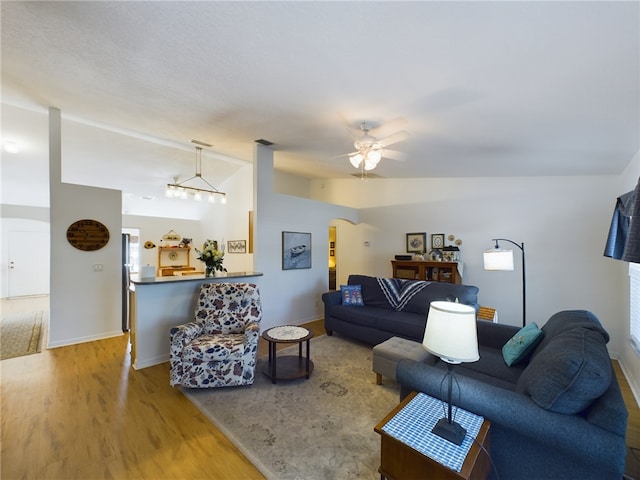 living room with ceiling fan, hardwood / wood-style floors, and lofted ceiling