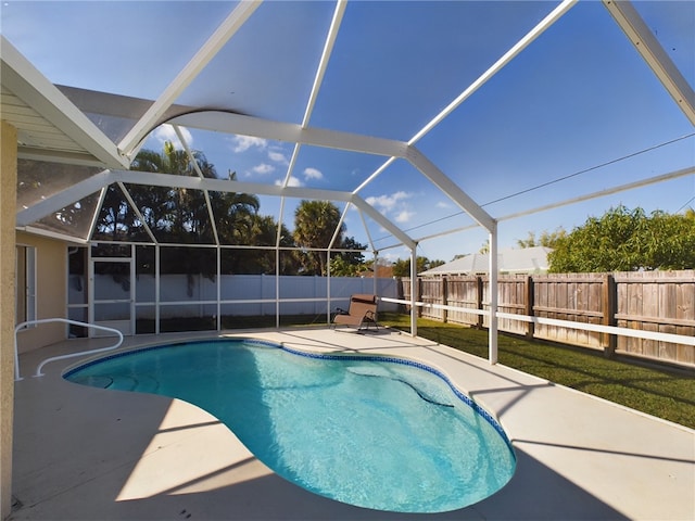 view of swimming pool with a lanai and a patio area