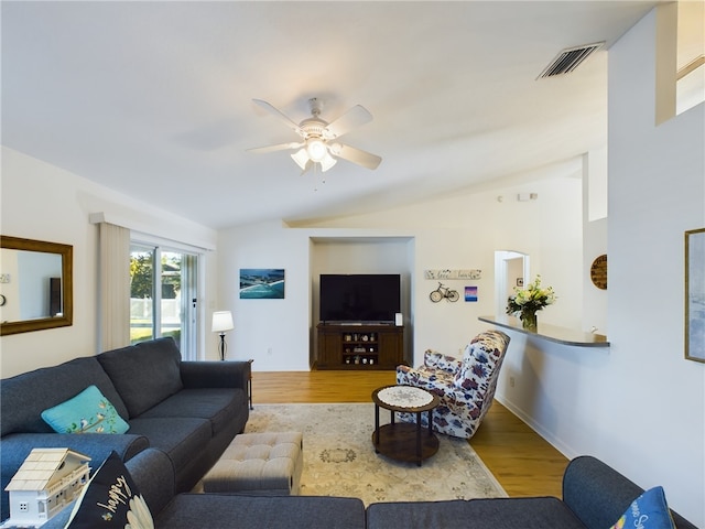 living room with ceiling fan, light hardwood / wood-style floors, and lofted ceiling