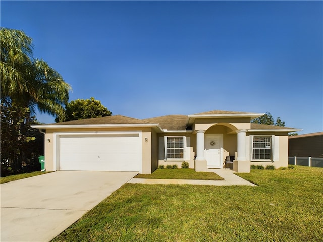 view of front of house featuring a garage and a front lawn