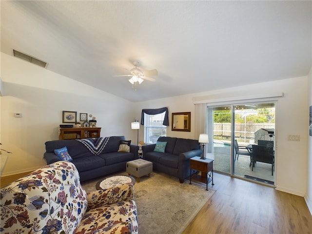 living room with hardwood / wood-style flooring and ceiling fan