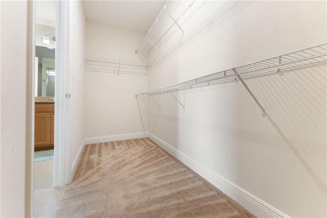 bedroom with a textured ceiling, light carpet, ceiling fan, and crown molding