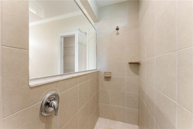 carpeted bedroom with ceiling fan, connected bathroom, a textured ceiling, and ornamental molding