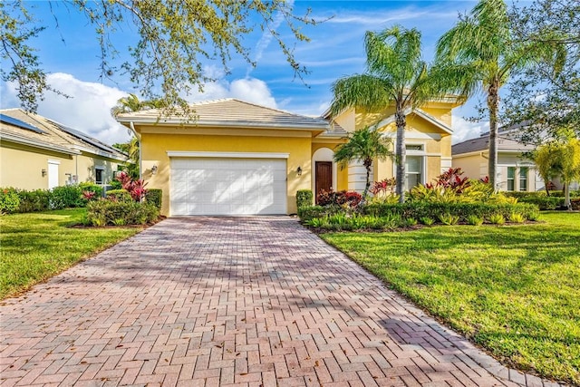 ranch-style house featuring a garage, stucco siding, decorative driveway, and a front yard