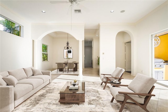 living room with visible vents, ornamental molding, recessed lighting, light tile patterned flooring, and arched walkways